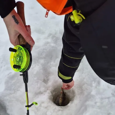 An ice-fishing hole drilled through the frozen lake