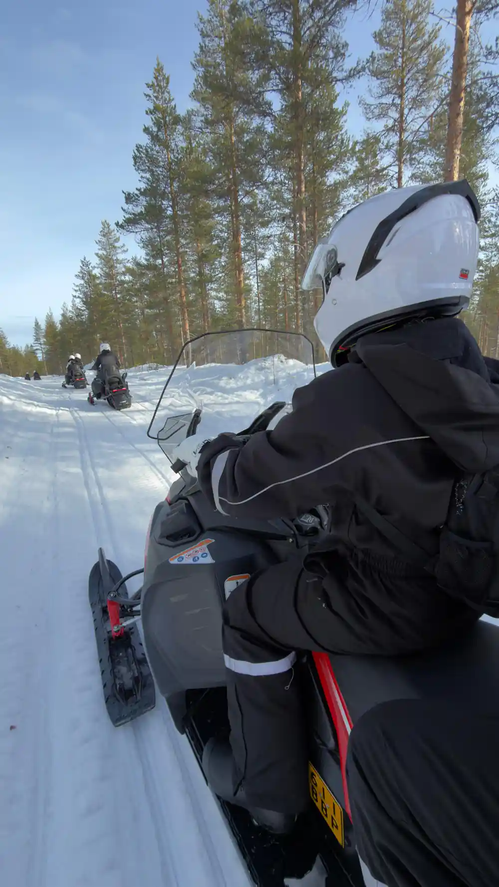 First-person view from snowmobile on snowy trail