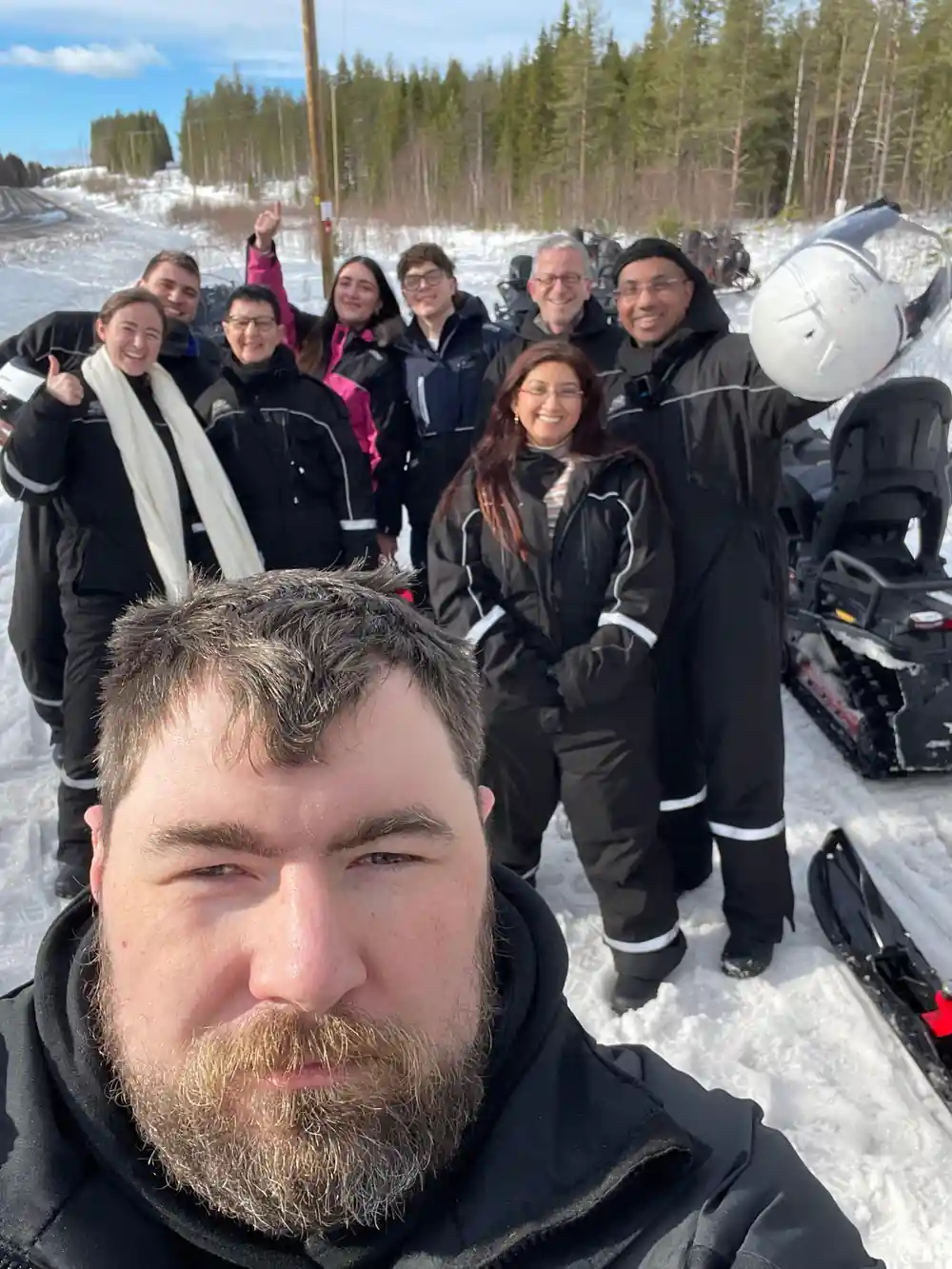 Group of people posing together in winter clothing outdoors