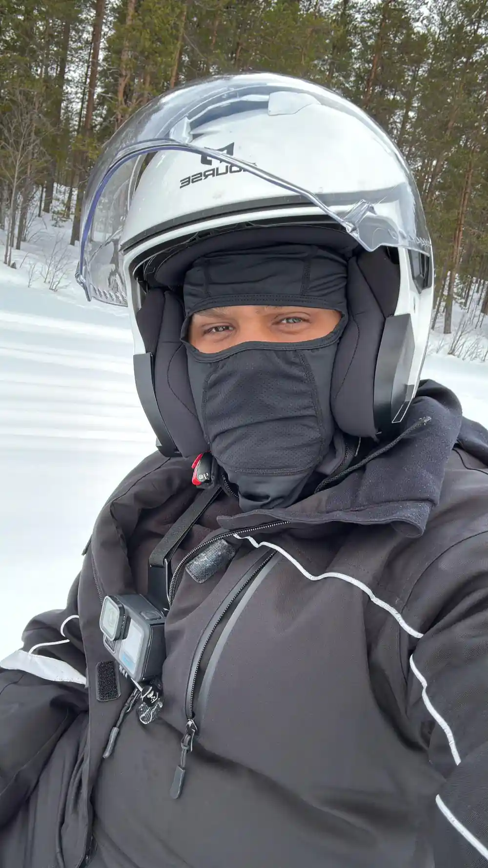 Person wearing helmet and face mask in winter gear